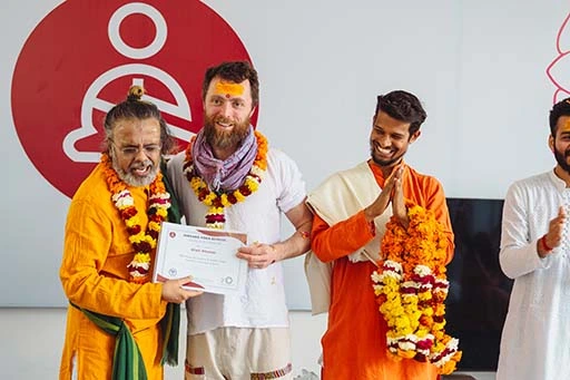 Nia Phelan with his Kundalini Yoga Teacher Training Certification at Nirvana Yoga School Rishikesh